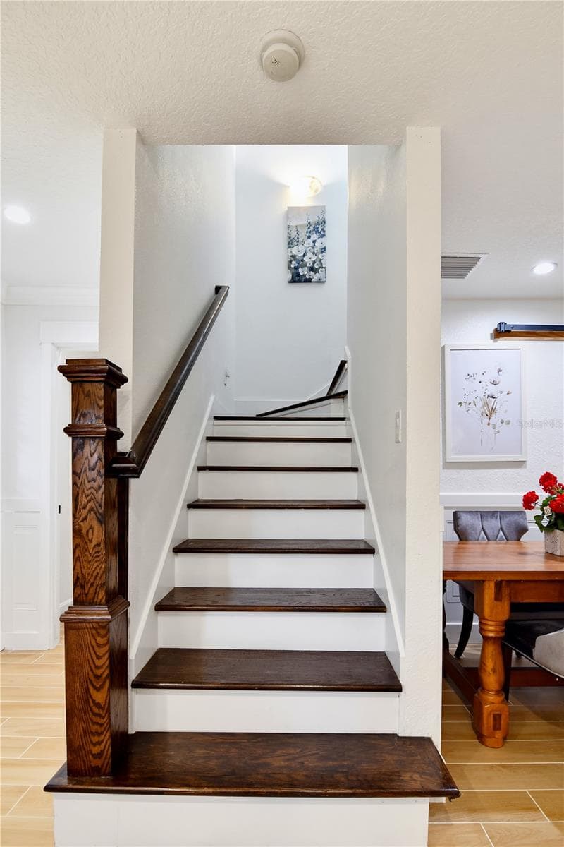 Interior staircase leading to the private second-floor primary suite. - 1611 CHESTNUT AVE, WINTER PARK
