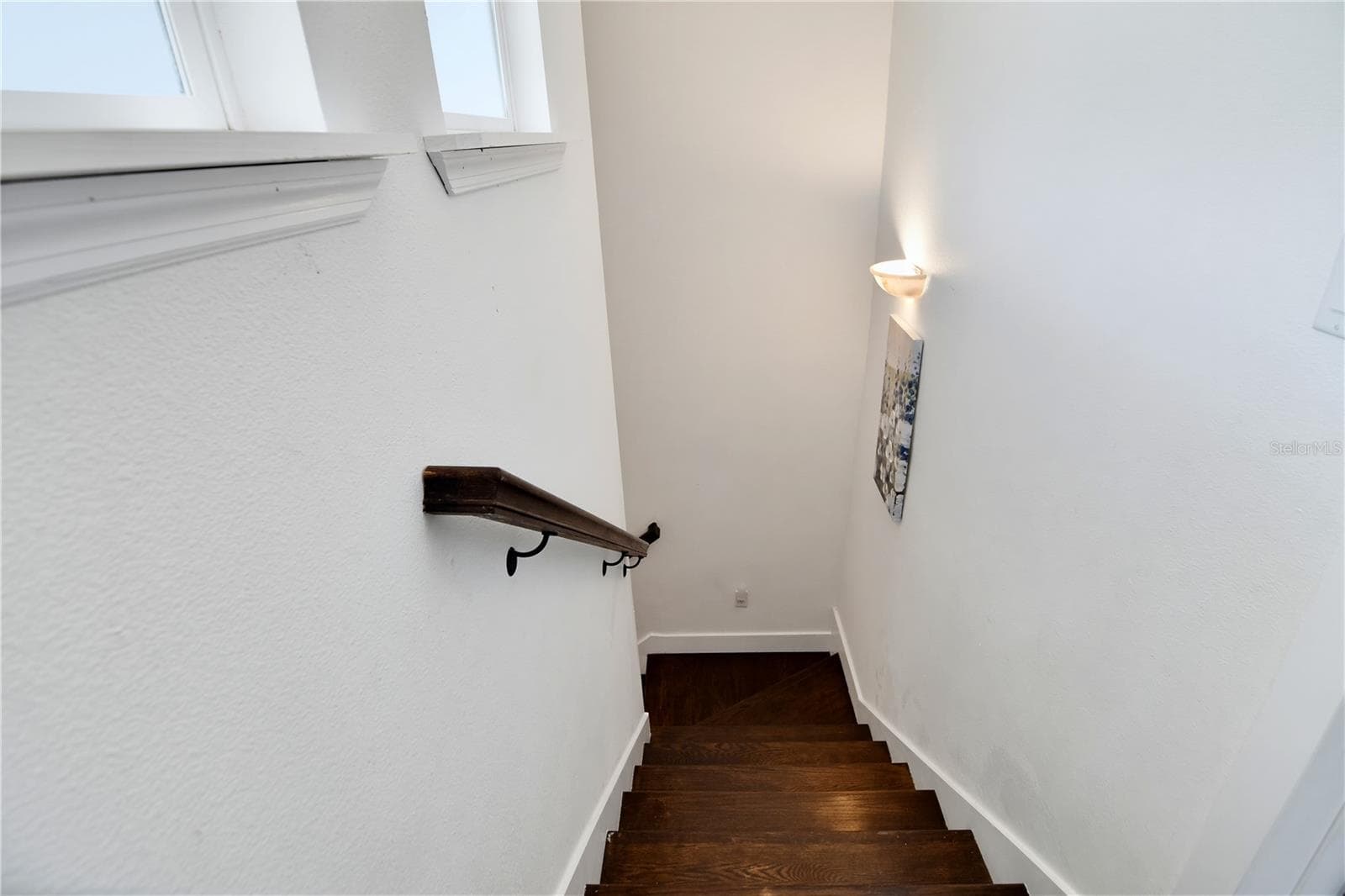 Additional staircase view with natural light and attractive wood accents. - 1611 CHESTNUT AVE, WINTER PARK