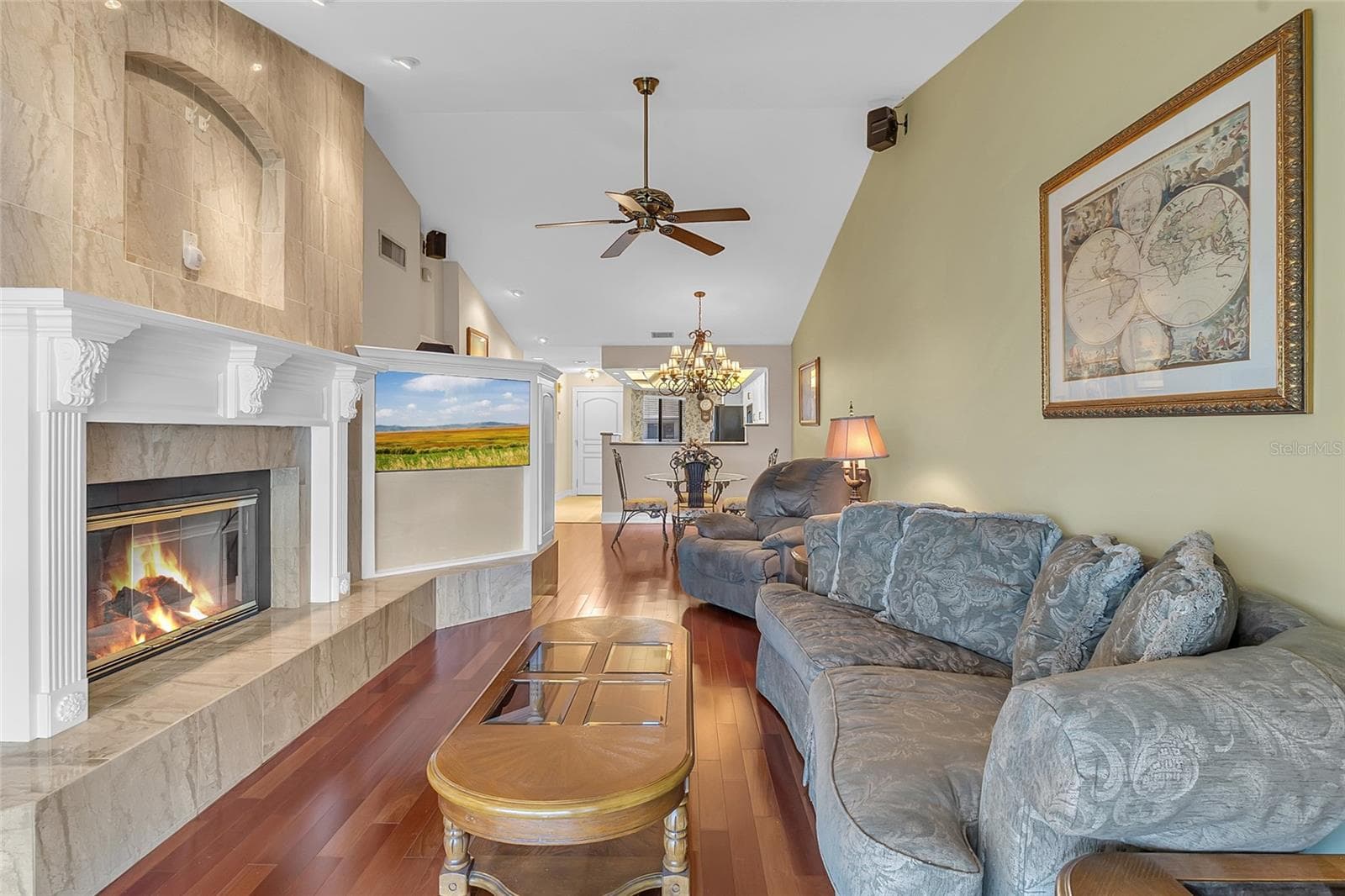 Spacious Living Room Featuring Vaulted Ceilings, Wood Flooring, Custom Built-Ins, and a Beautiful Fireplace - 4113 FAIRVIEW VISTA PT #311, ORLANDO