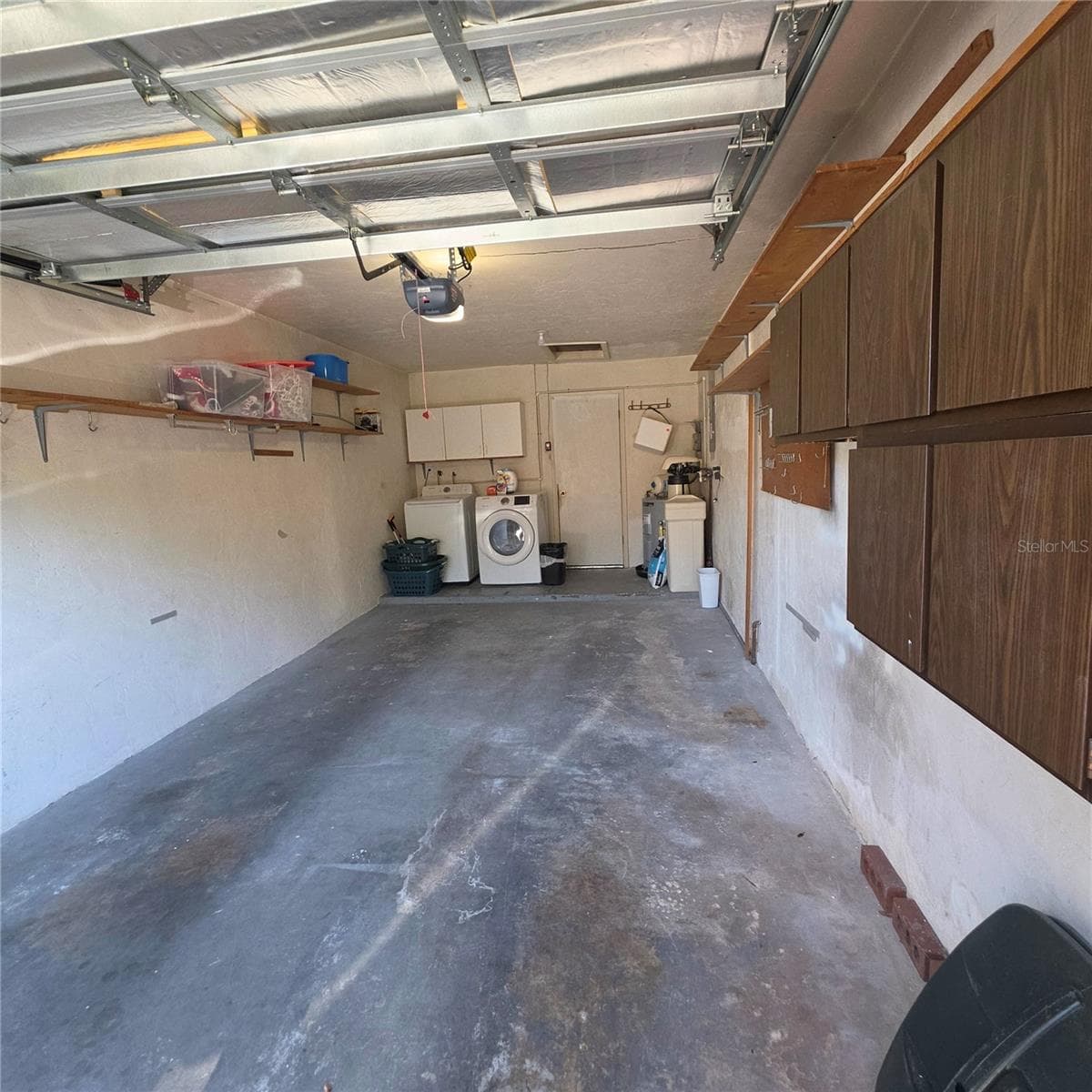 Garage with cabinets and washer and dryer - 2101 SUNSET POINT RD #2603, CLEARWATER