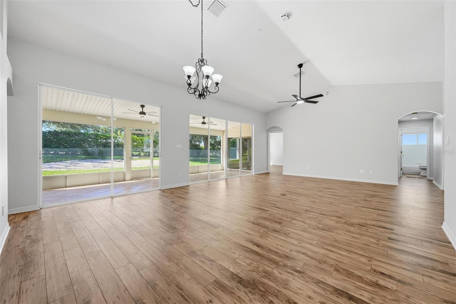 Open Living and Dining Room overlooking the backyard - 24809 RIVERBOAT BND, LEESBURG