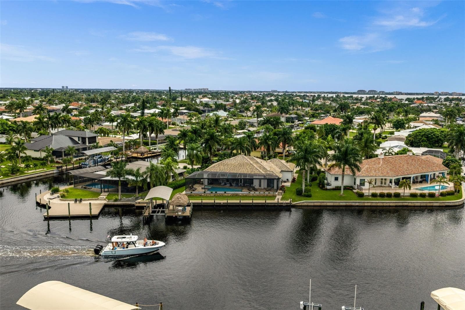 Watch the boats go by on the famous, extra-wide Bimini Canal - 5205 SUNSET CT, CAPE CORAL