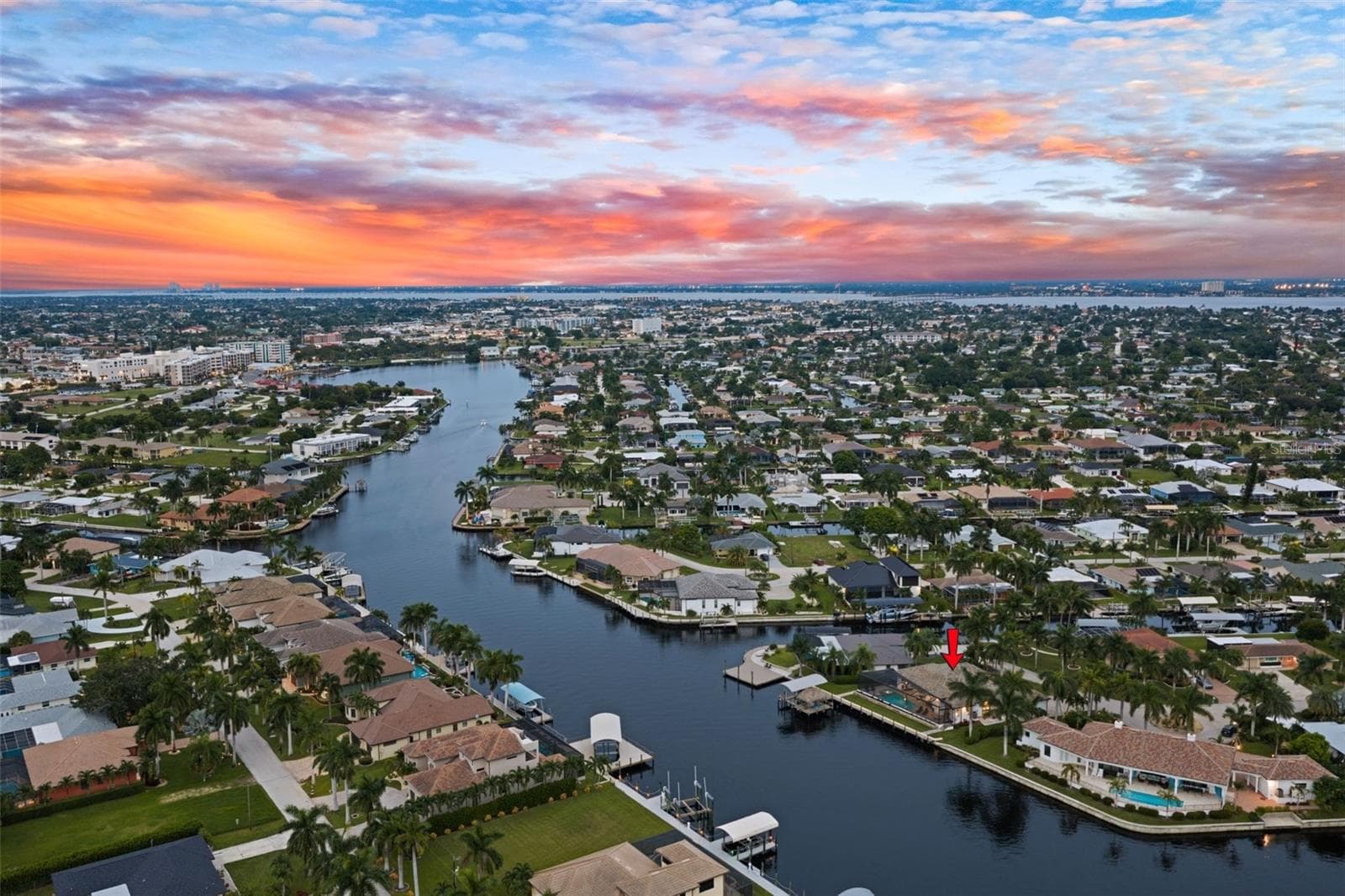 Aerial evening view with Bimini Square and Downtown Cape Coral in the background - 5205 SUNSET CT, CAPE CORAL