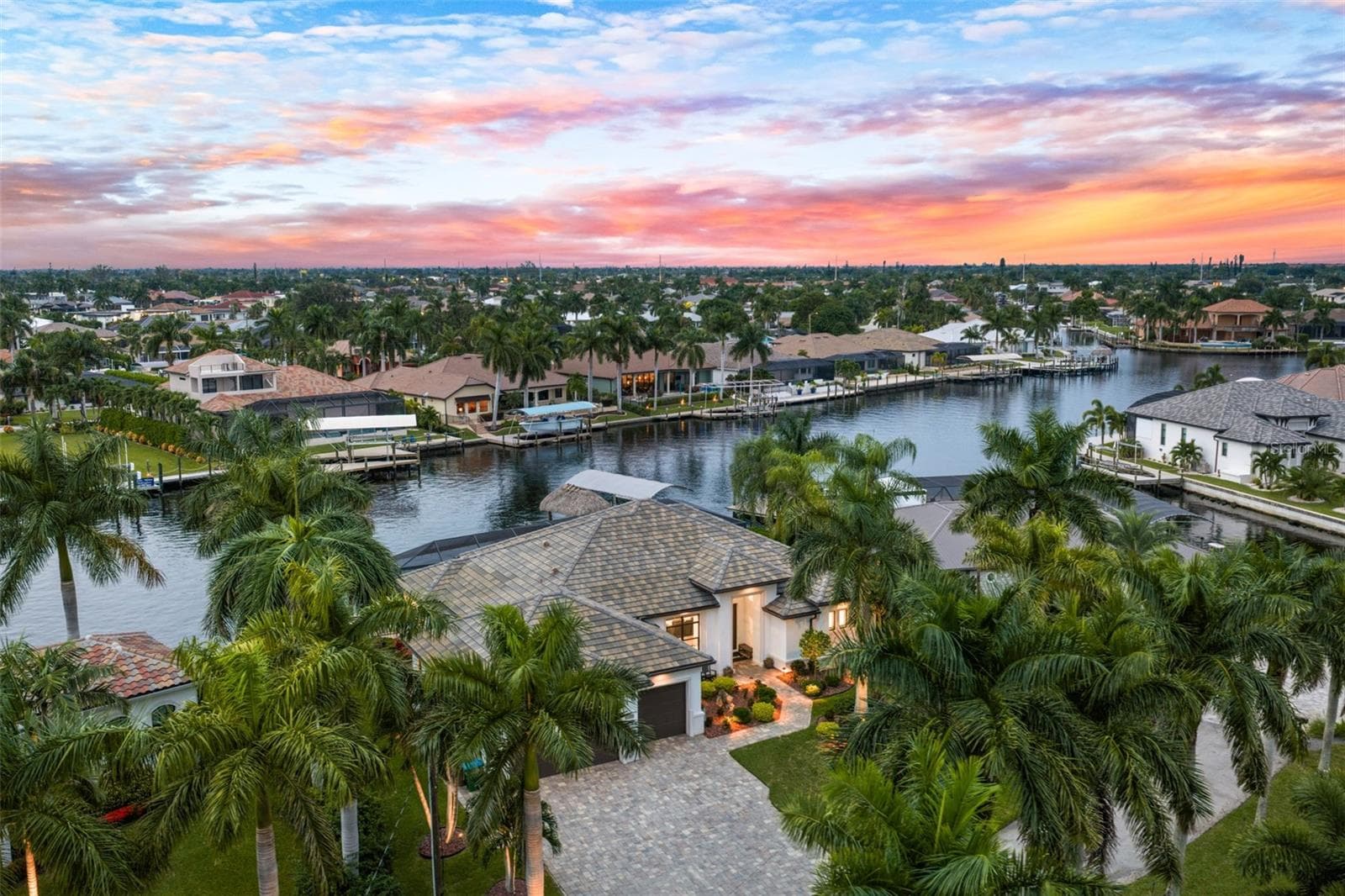 Aerial evening view - 5205 SUNSET CT, CAPE CORAL