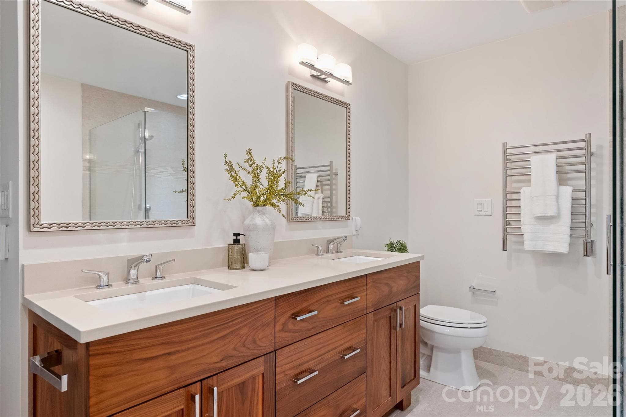 The Primary Bath features a custom handsome walnut vanity with double cast under-mount sinks. - 201 Hillside Avenue, Charlotte