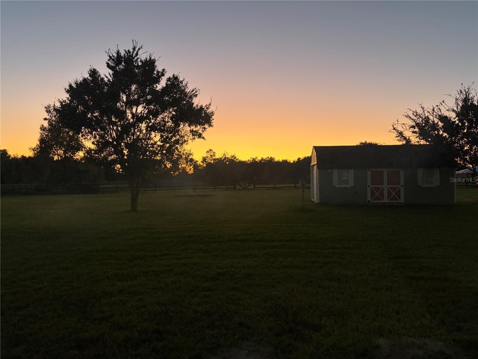 Sunset from back screened in porch - 9574 SW 102ND TER, GAINESVILLE