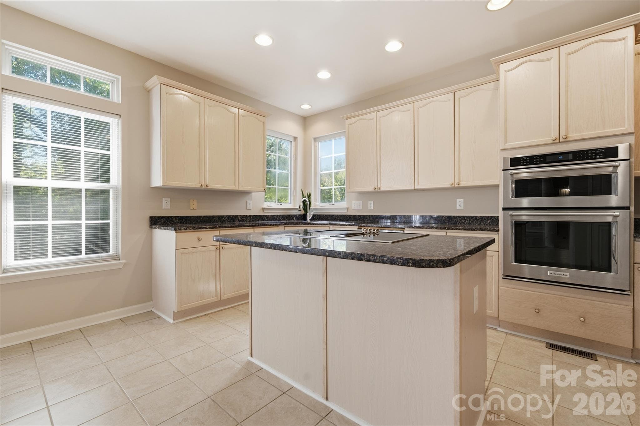 Kitchen with stainless steel appliances, island, and granite countertops - 6211 Chavel Lane, Charlotte