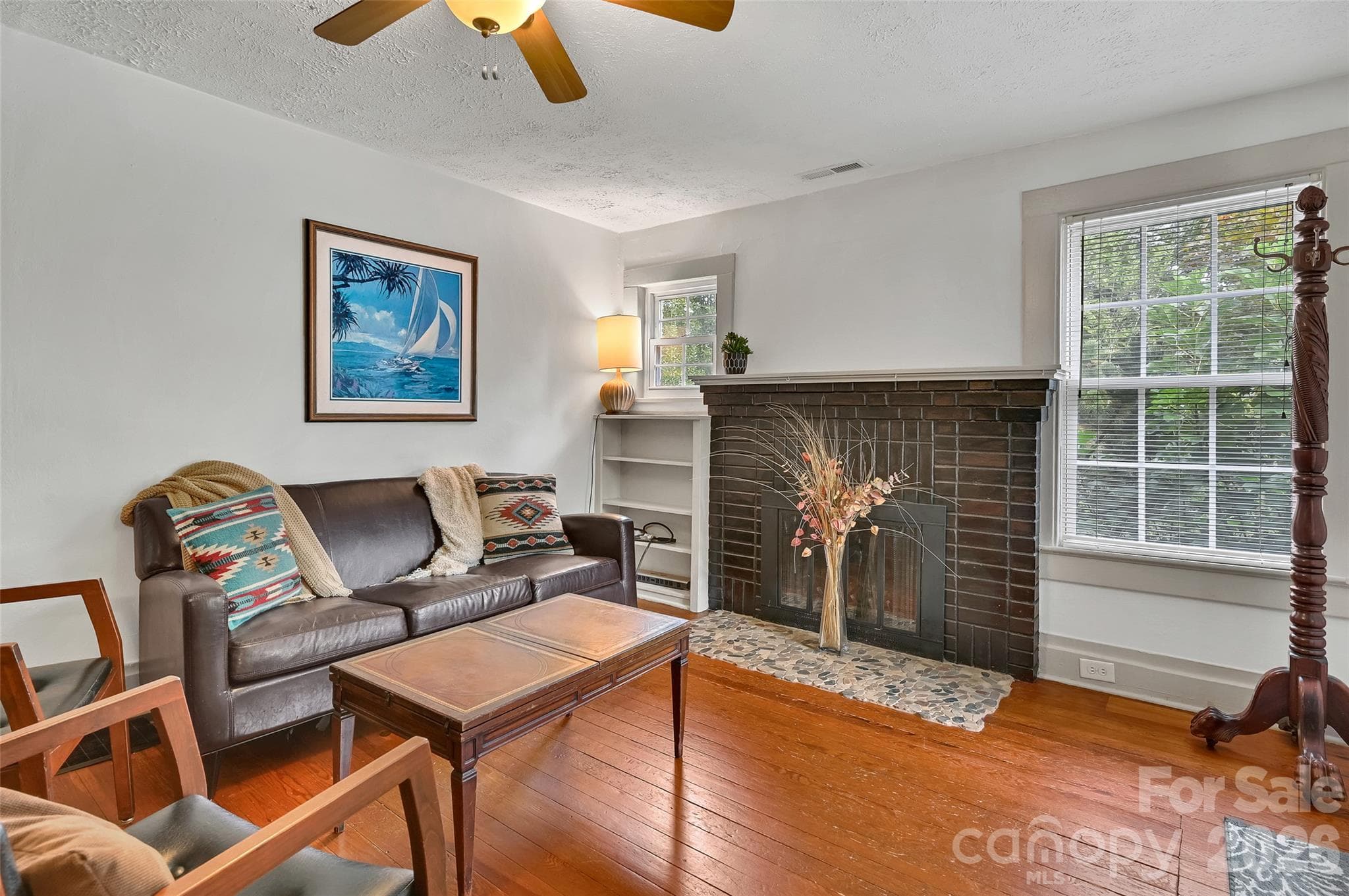 Living room with fireplace. Owner is installing a natural gas insert - 209 Old Haw Creek Road, Asheville