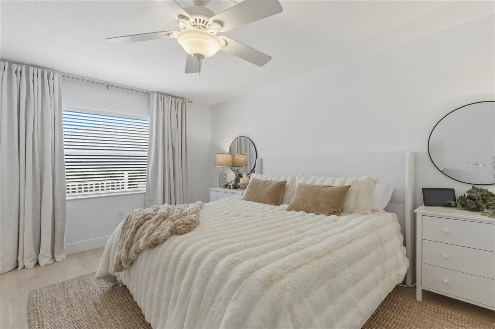Primary bedroom, light and bright with darken curtains. Plenty big for a King size bed set. - 4642 SAINT LAWRENCE DR, NEW PORT RICHEY