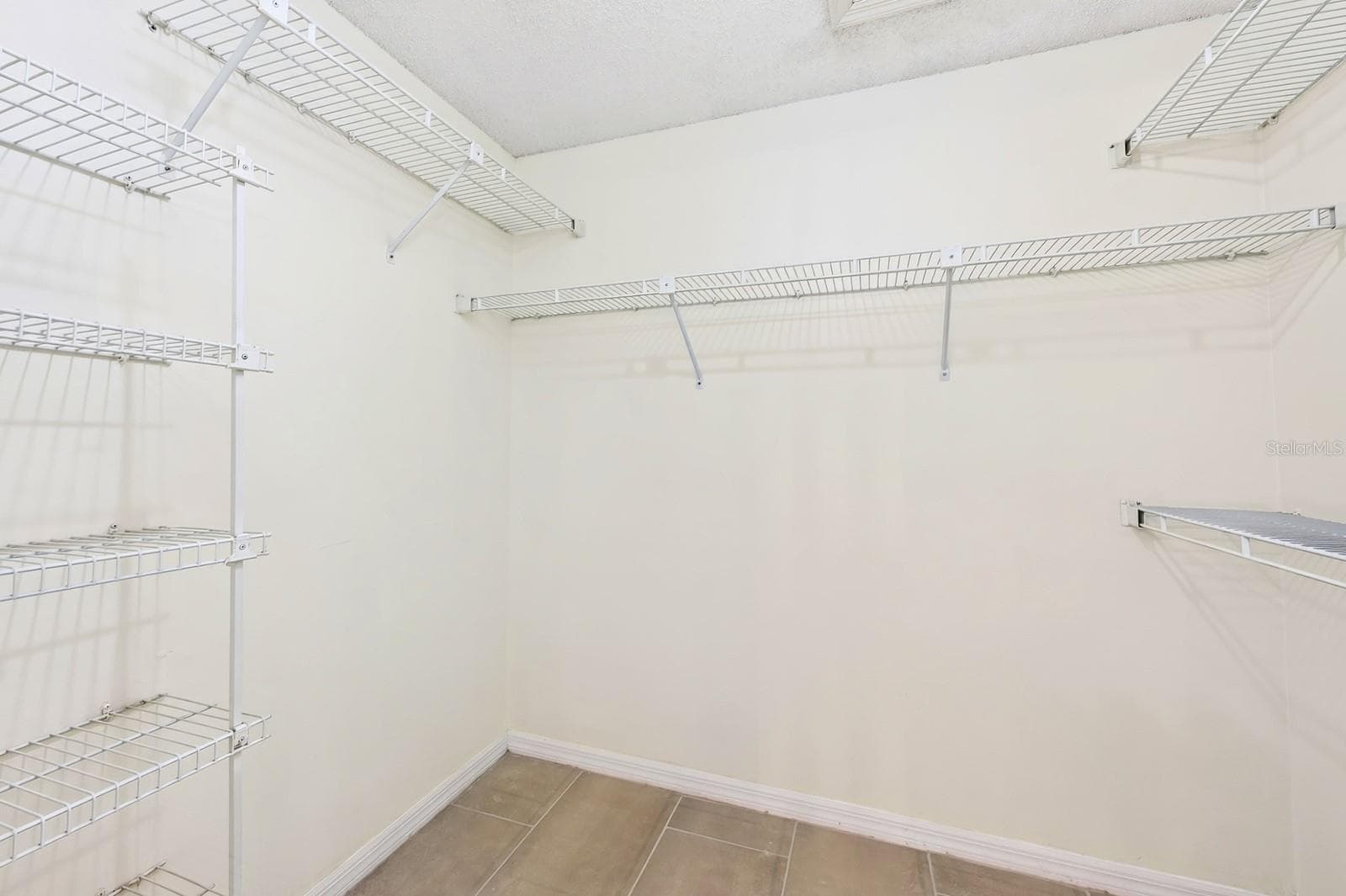 The Primary walk-in closet provides generous storage. - 1003 N MAGEE CREEK CT, OVIEDO