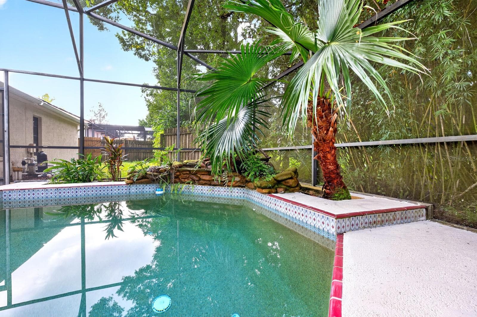 The in-ground pool and screened lanai create the perfect setting for swimming, relaxing and entertaining year-round. - 1003 N MAGEE CREEK CT, OVIEDO