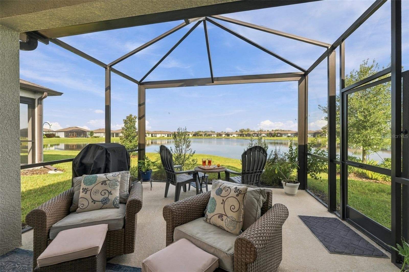Extra living space under the covered porch and grow your favorite plants in the open lanai. - 9260 BALLASTER POINTE LOOP, PARRISH