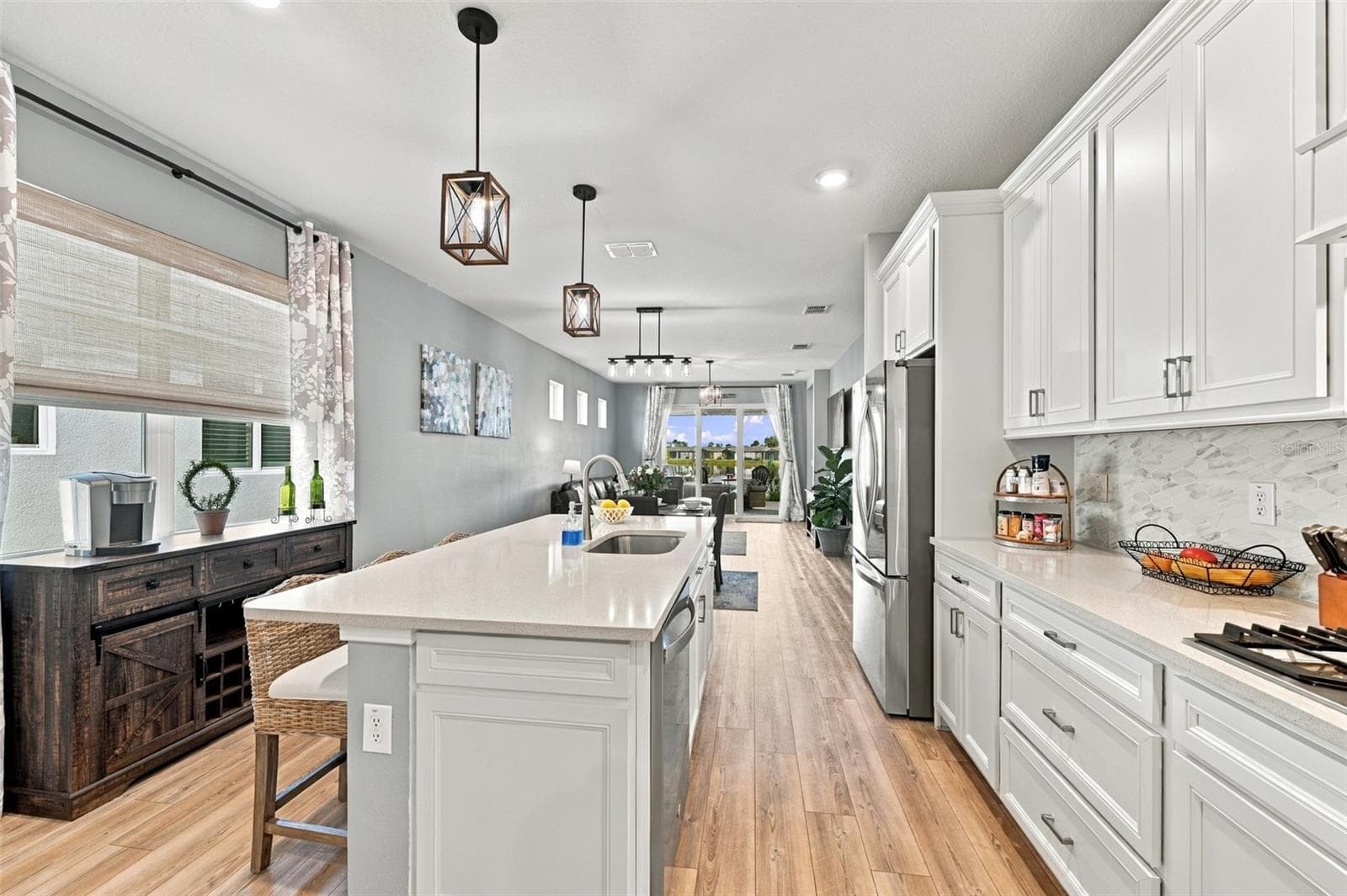 This Bright Kitchen is situated toward the front of the house adorned by large double pane windows shades and curtains included! - 9260 BALLASTER POINTE LOOP, PARRISH