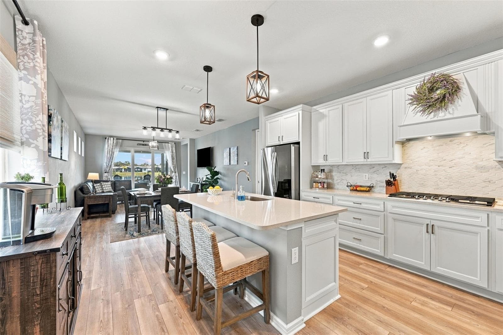 This fabulous Kitchen comes furnished with cushion Bar stools, Coffee Bar and Dining Table for four. - 9260 BALLASTER POINTE LOOP, PARRISH