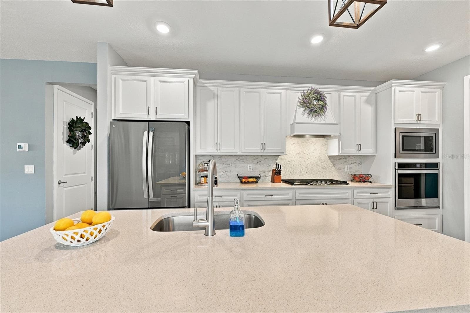 Considerable Quartz countertops and decorater backsplash enhance this kitchen. - 9260 BALLASTER POINTE LOOP, PARRISH