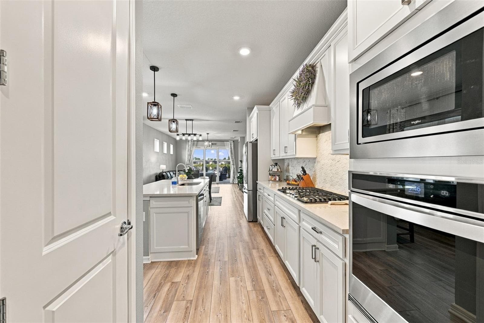 Plenty of storage here, closet pantry and soft close cabnetry. Double Wall Oven and Gas Cooktop with Custom Vent Hood compliment this Luxury Kitchen. - 9260 BALLASTER POINTE LOOP, PARRISH