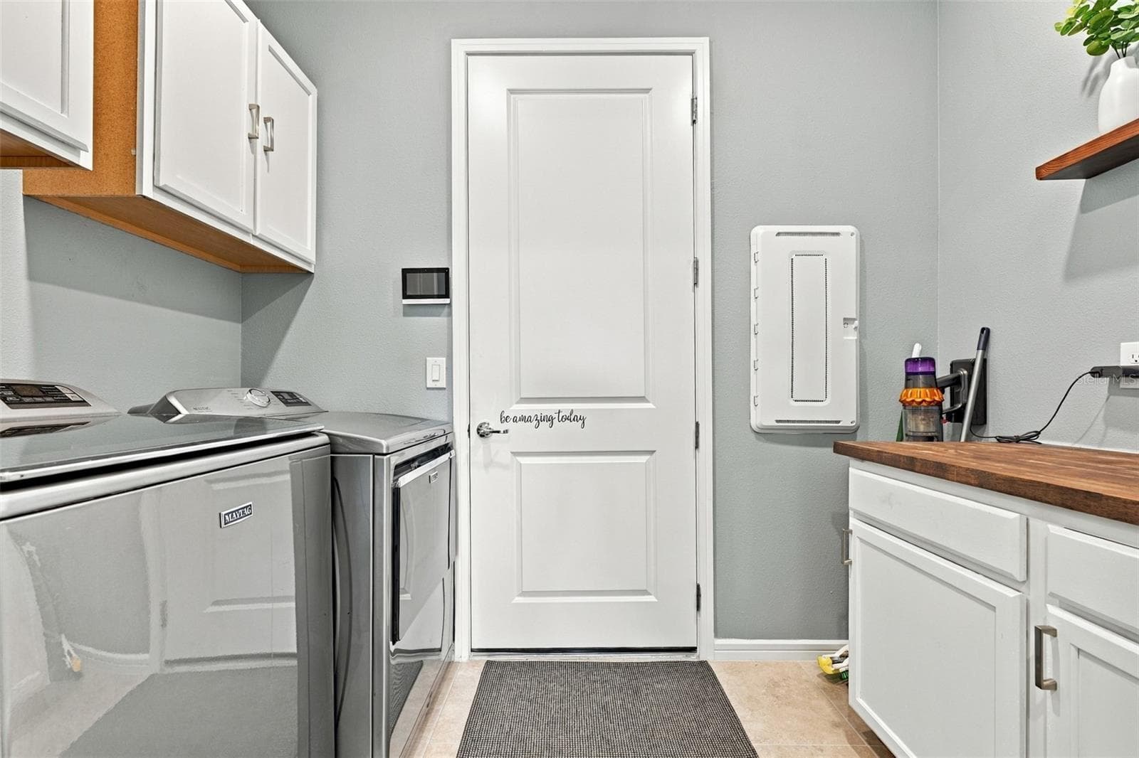 Top of the line Washer and Dryer, wall and cabinet storage in this well appointed furnished laundry room. - 9260 BALLASTER POINTE LOOP, PARRISH