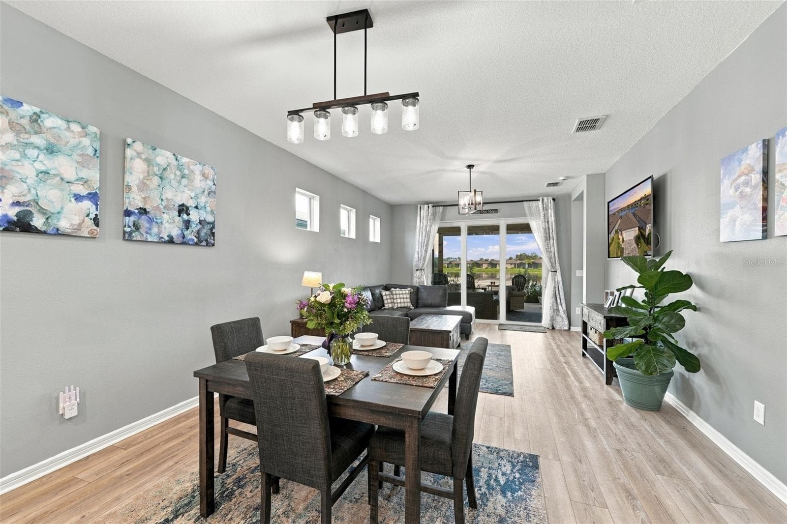 Dining open to the Family Room.. Updated lighting throughout the home. - 9260 BALLASTER POINTE LOOP, PARRISH