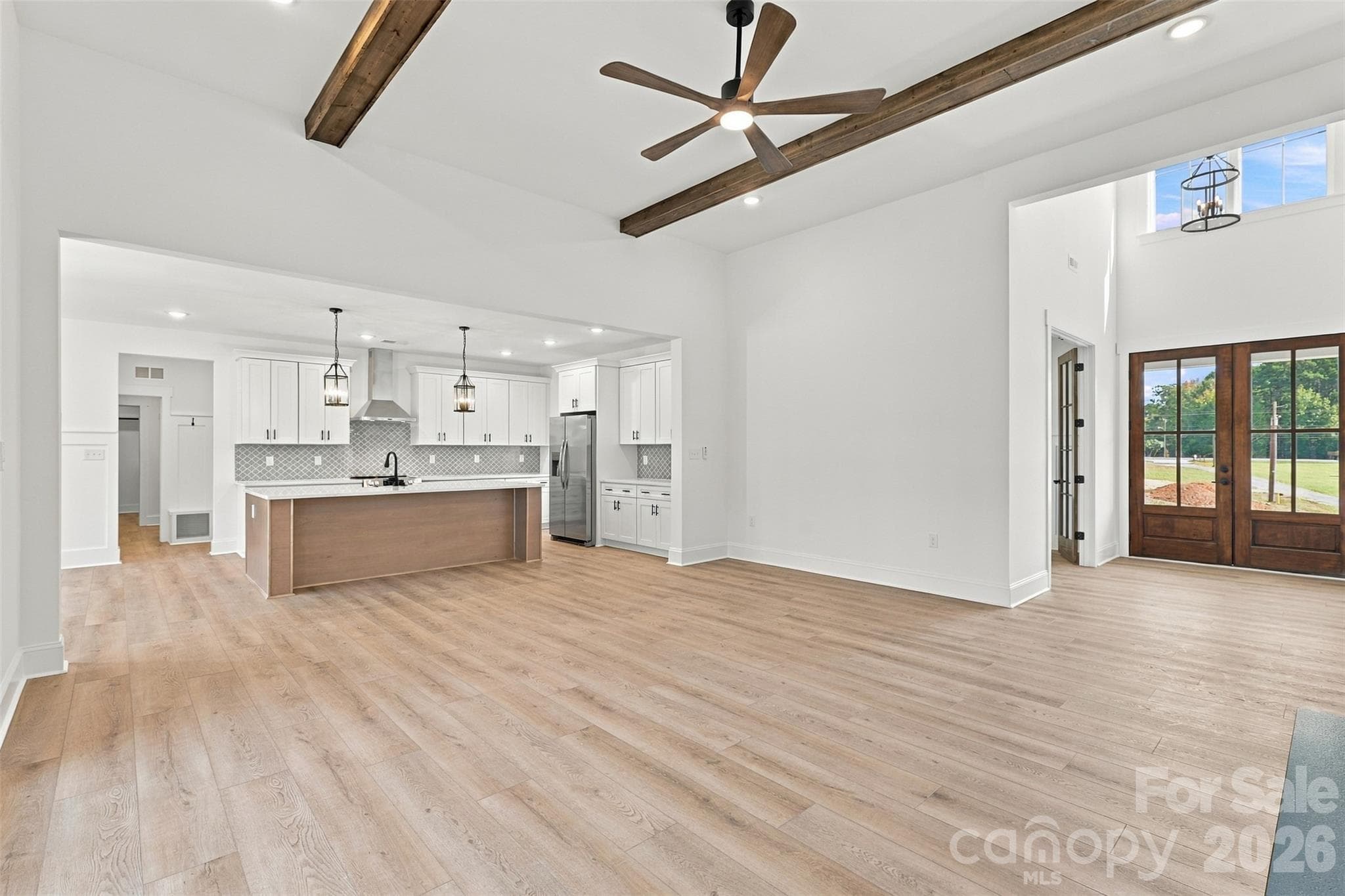 Living room- 12 ft ceilings, stained beams, electric shiplap fireplace, built-ins - 394 S NC 200 Highway, Stanfield