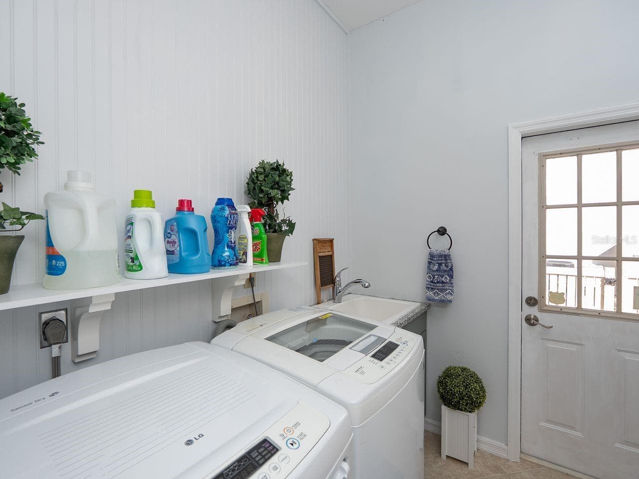 inside laundry room with door to side of house by outside shower - 71 CAYMAN ISLES BLVD, ENGLEWOOD