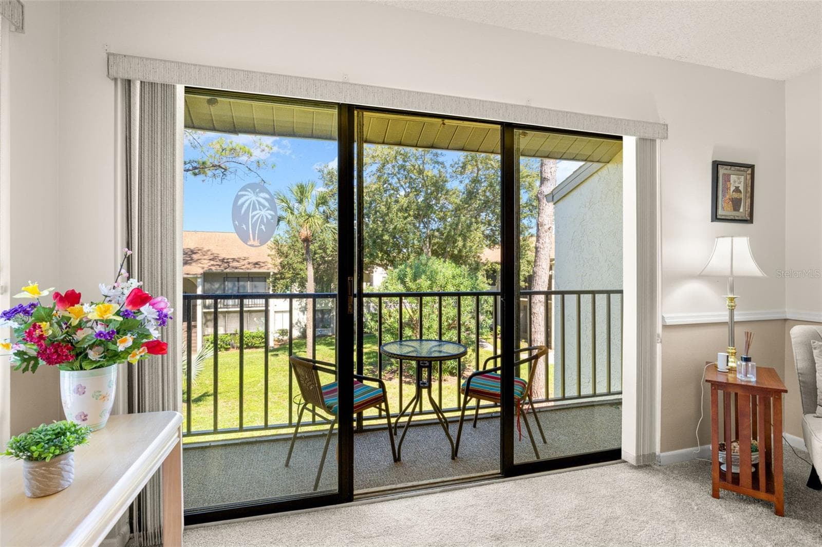 View of porch from living room - 1708 PINE RIDGE WAY E #B2, PALM HARBOR