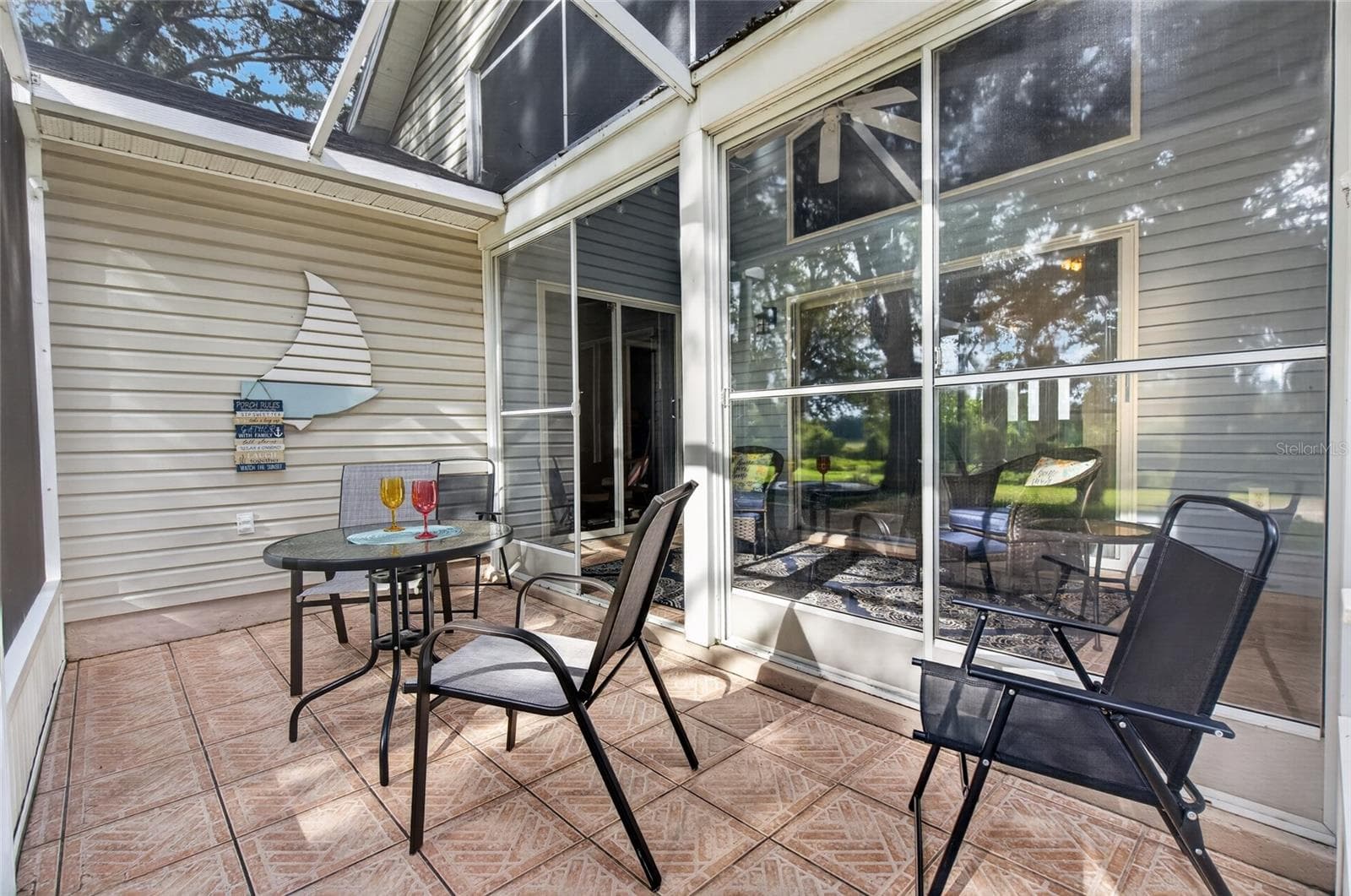 Screened Lanai overlooks wooded backyard and golf course - 25005 CRANES ROOST CIR, LEESBURG