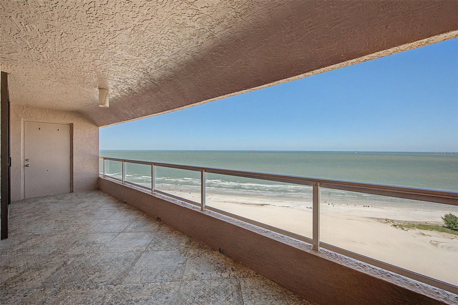 Step out onto the balcony from the Living area - 1310 GULF BLVD #14E, CLEARWATER