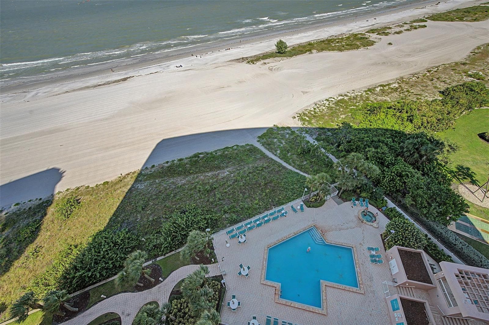 Looking down on the Community pool for the building. - 1310 GULF BLVD #14E, CLEARWATER