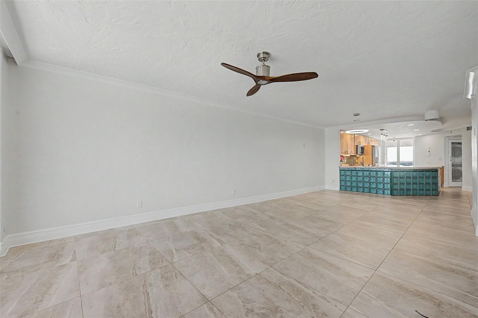 Step back in from the balcony to the Living area and looking into the kitchen. - 1310 GULF BLVD #14E, CLEARWATER