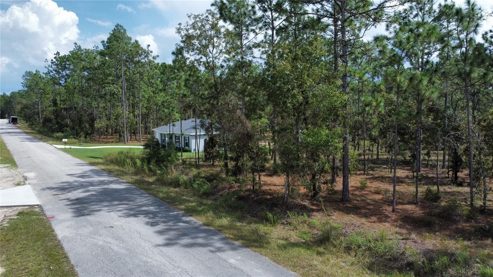 There is a home to the east of the lot - TBD NW TAMARIND LN, DUNNELLON