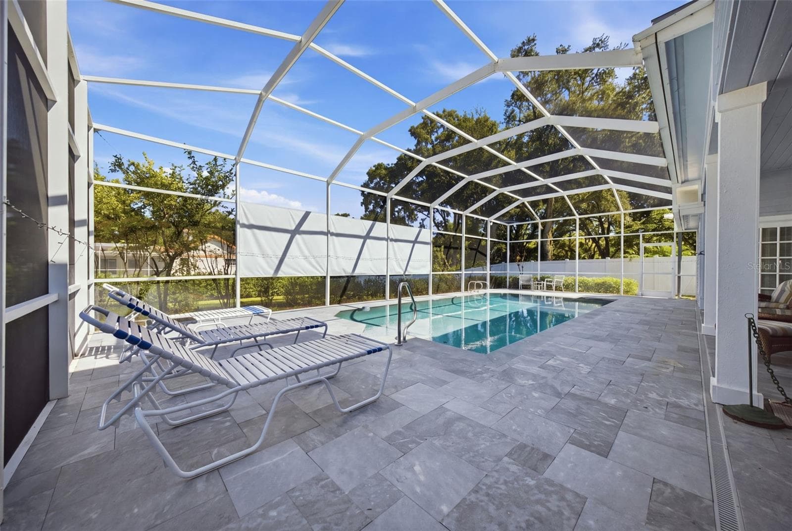 Enclosed Pool and Lanai in blue slate tile. - 12383 WINDTREE BLVD, SEMINOLE