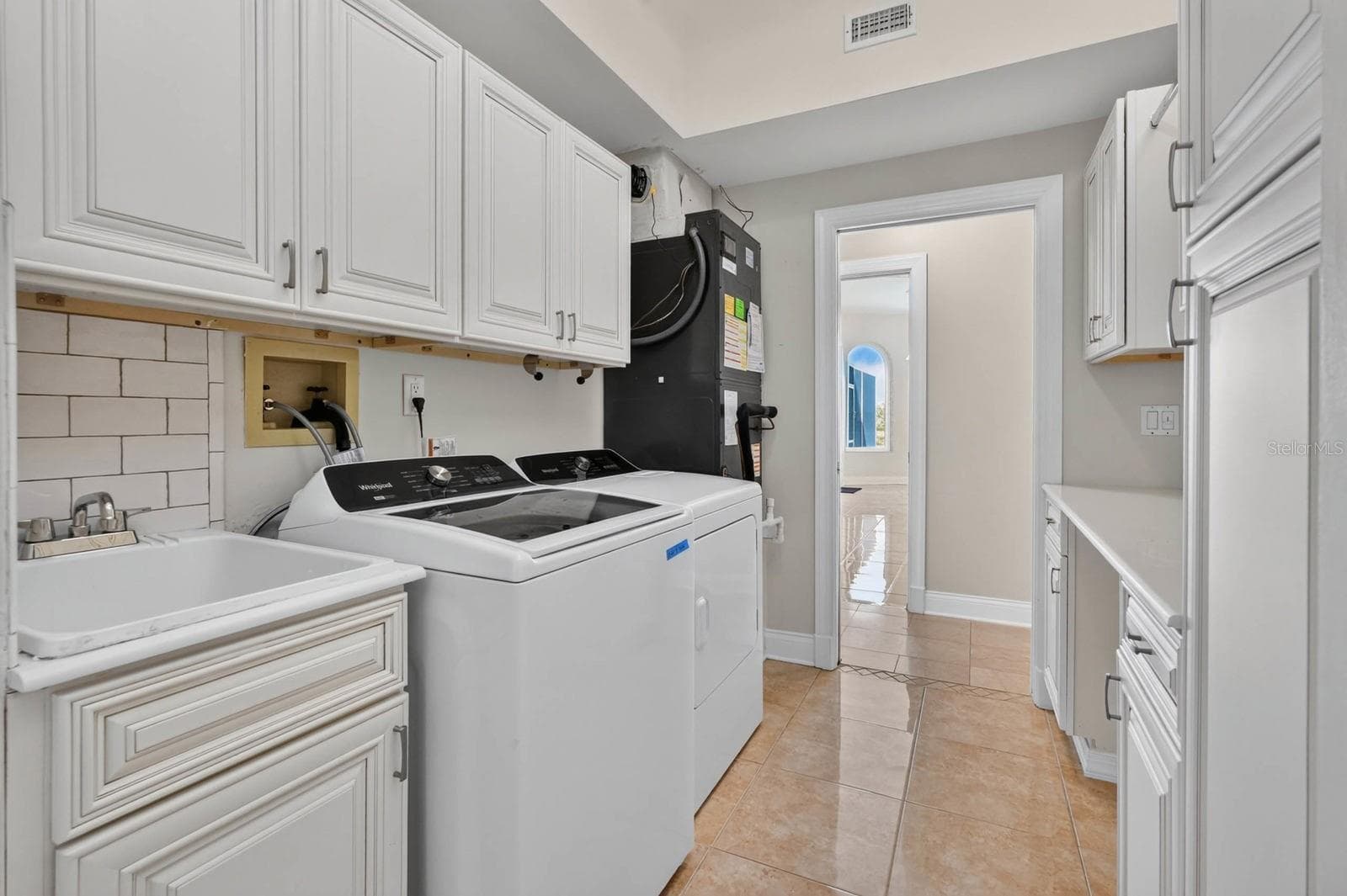 Laundry Room With Storage Cabinets - 74 COVINGTON LN, PALM COAST