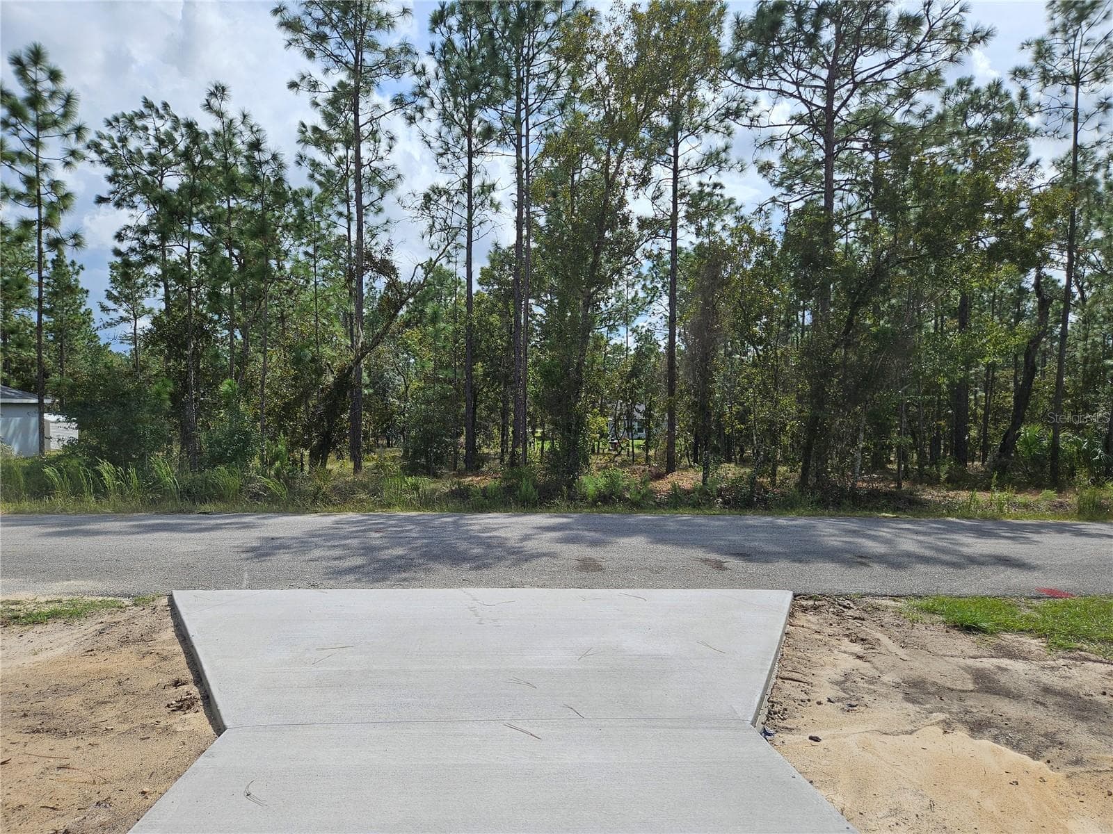 There is a home directly in front of the lot - TBD NW TAMARIND LN, DUNNELLON