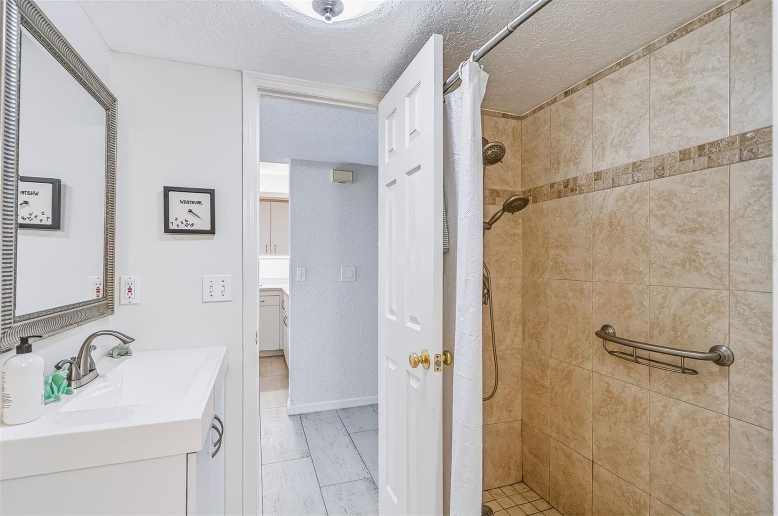 bathroom with walk in shower - 406 BOUCHELLE DR #103, NEW SMYRNA BEACH