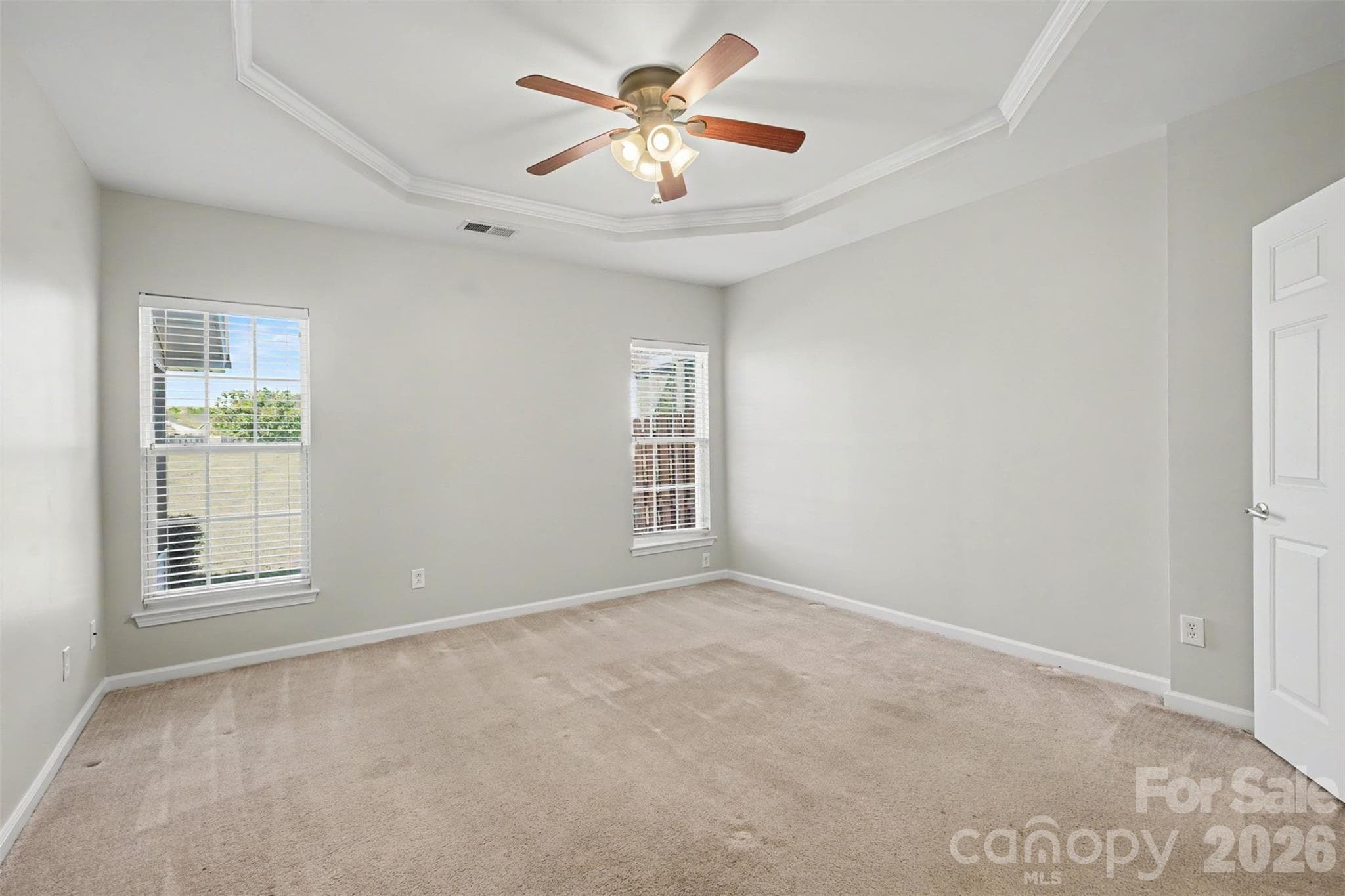 Main level primary bedroom with trey ceiling - 4083 Holly Villa Circle, Indian Trail