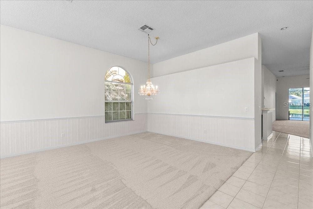 dining room area, then on to the kitchen and family room - 477 LAKEPARK TRL, OVIEDO