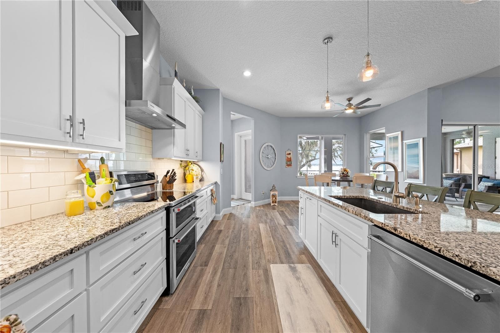 Kitchen with soft close drawers, double oven and granite countertops - 590 EDEN DR, ST CLOUD