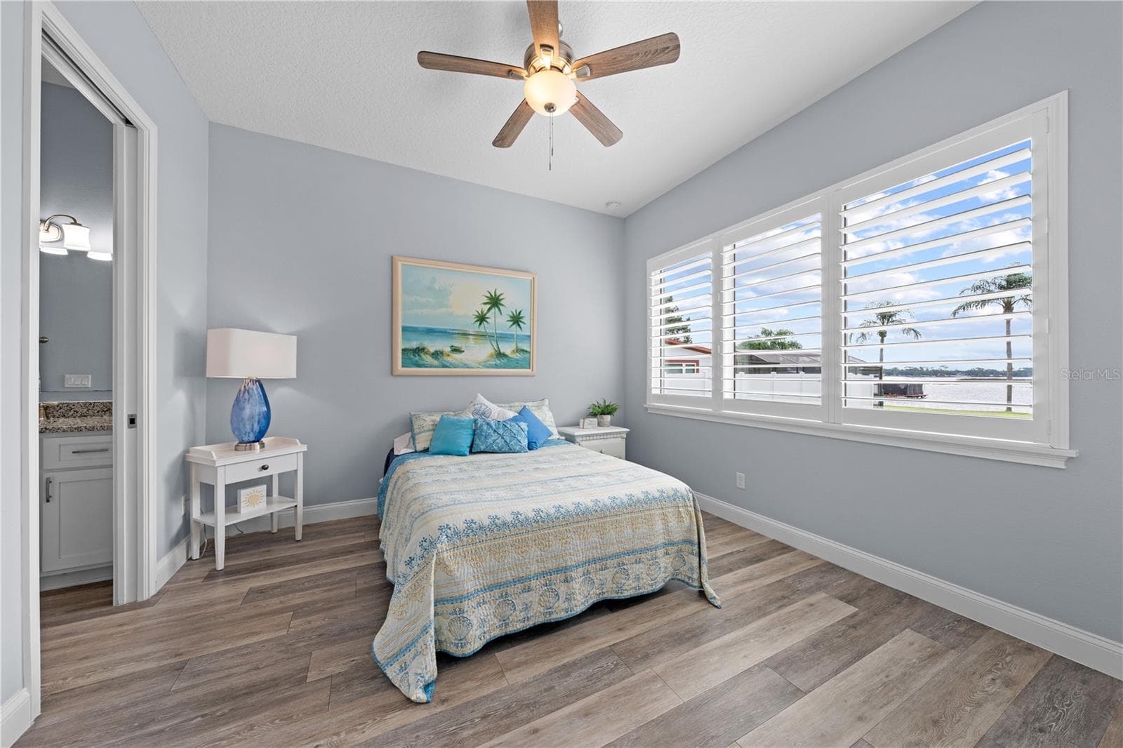 2nd primary bedroom with plantation shutters overlooking the lake - 590 EDEN DR, ST CLOUD