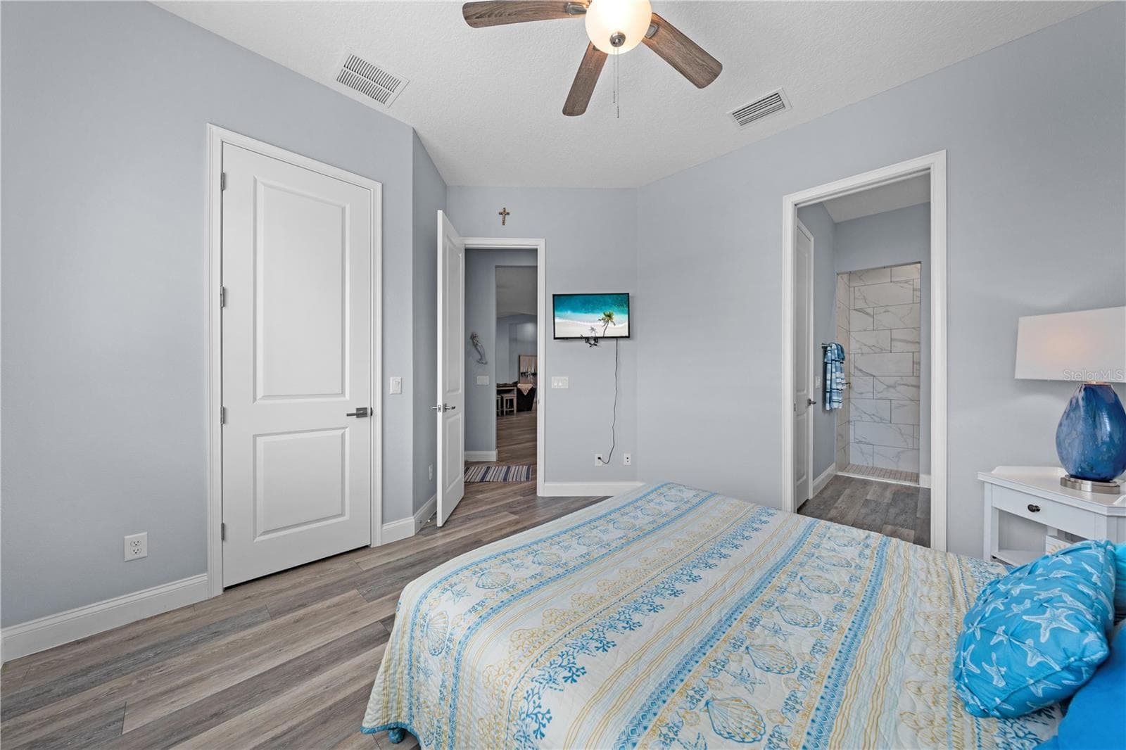 2nd primary bedroom with plantation shutters overlooking the lake - 590 EDEN DR, ST CLOUD