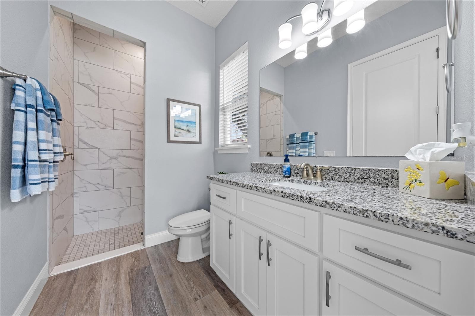2nd primary bathroom with granite with single vanity and rain showerhead - 590 EDEN DR, ST CLOUD