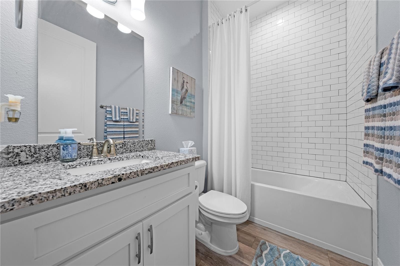 Bathroom 3 with granite countertops, single vanity and shower/tub. - 590 EDEN DR, ST CLOUD