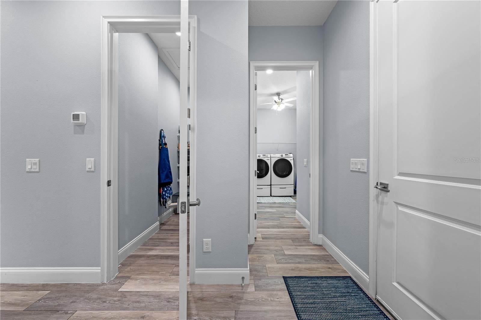 Entrance to the pantry on the left and laundry room on the right. - 590 EDEN DR, ST CLOUD