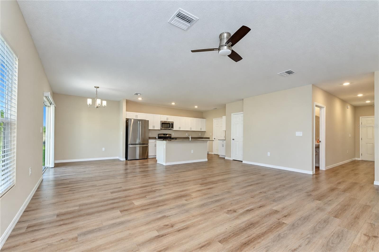 Inviting gathering area with an open connection to the kitchen and dining space. - 11484 BROOK EDGE AVE, RIVERVIEW