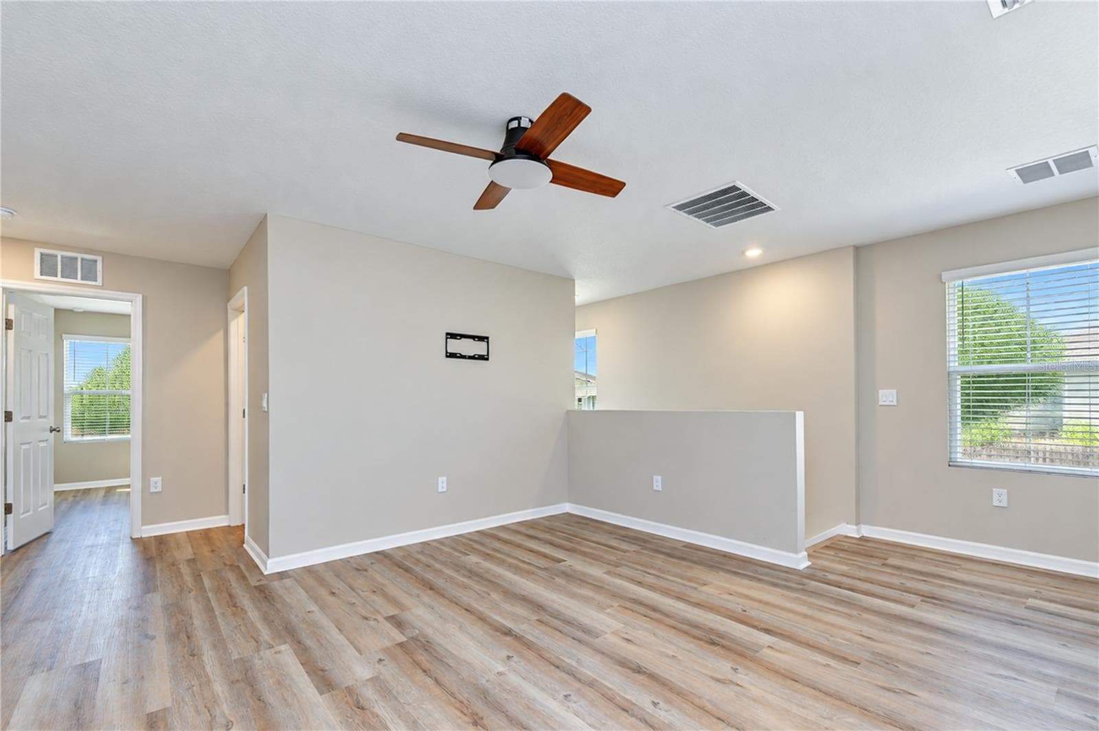Versatile upstairs living area for a media room, playroom, home office, or additional gathering space. - 11484 BROOK EDGE AVE, RIVERVIEW