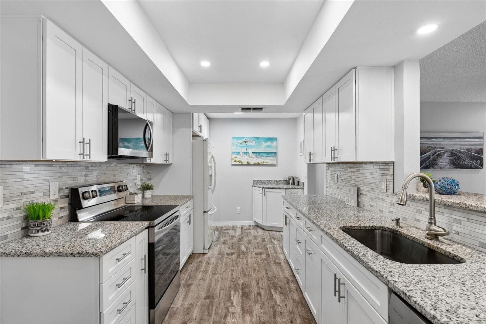 Remodeled kitchen with white shaker cabinets, granite countertops - 1307 STONEHAVEN LN, DUNEDIN