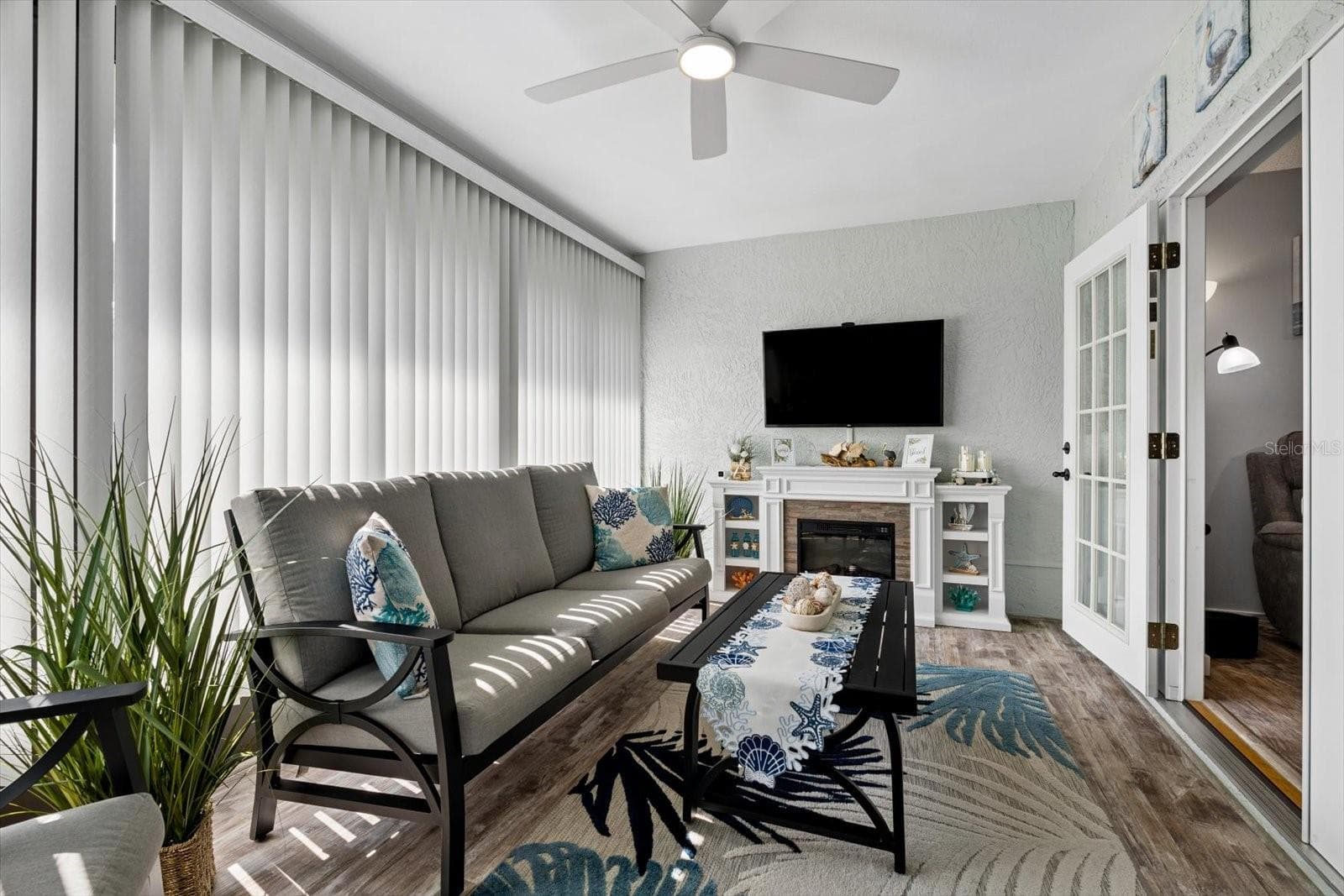 French doors leading to enclosed Lanai off the living room - 1307 STONEHAVEN LN, DUNEDIN