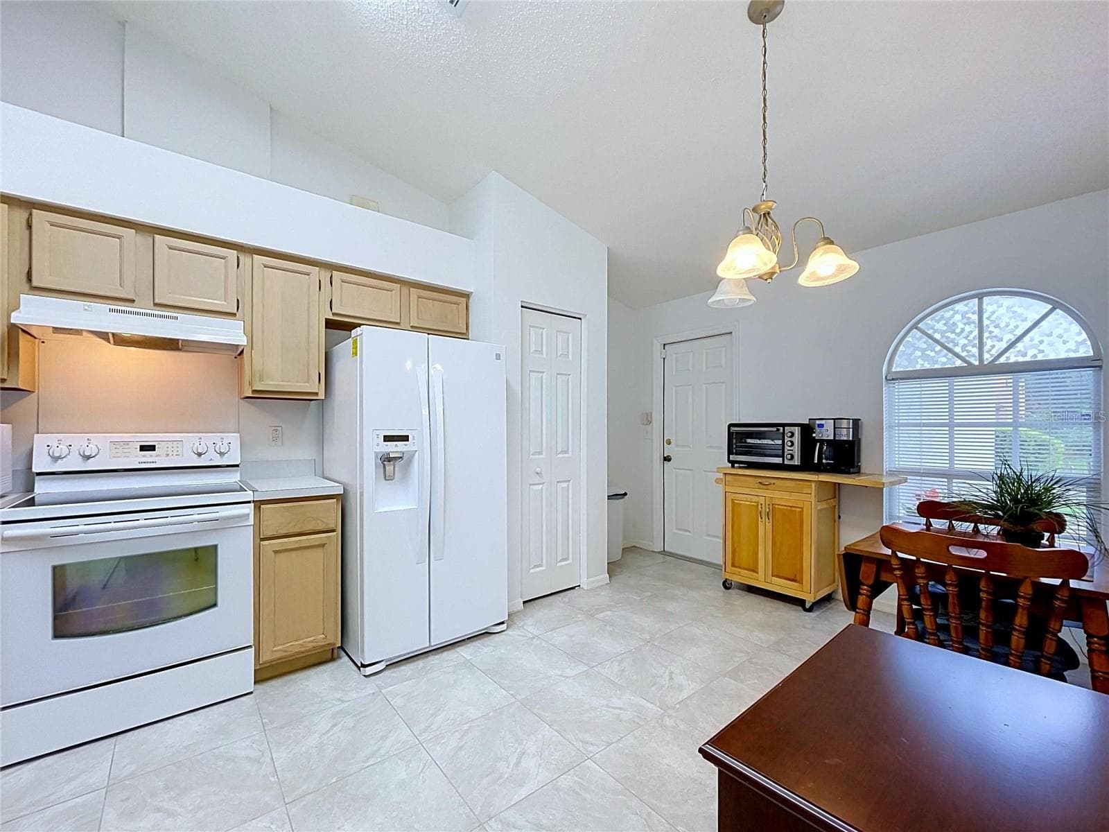 Built-in pantry is by refrigerator - 27408 CORAL SPRINGS DR, WESLEY CHAPEL