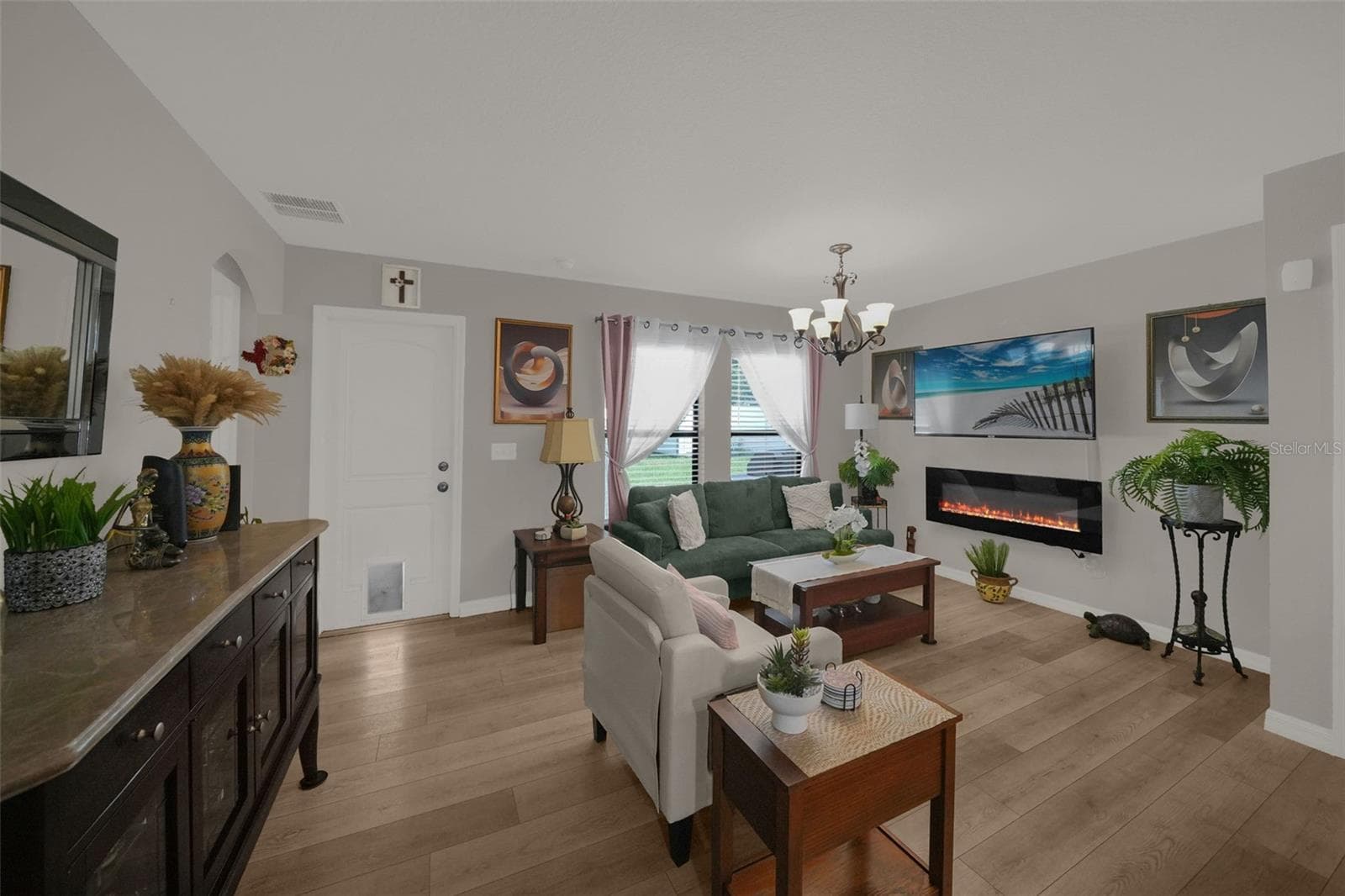 Living room with built-in electric fireplace - 26448 BERTRAM RD, BROOKSVILLE