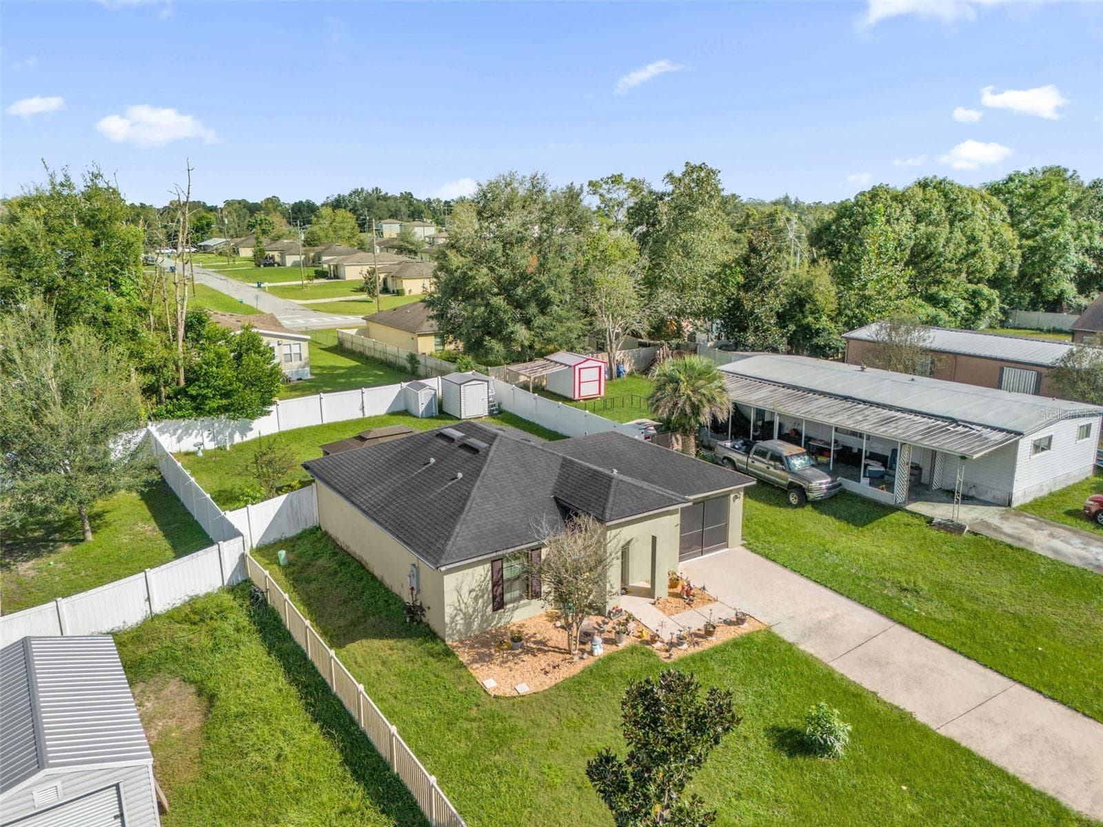 Aerial view of home and fenced backyard - 26448 BERTRAM RD, BROOKSVILLE