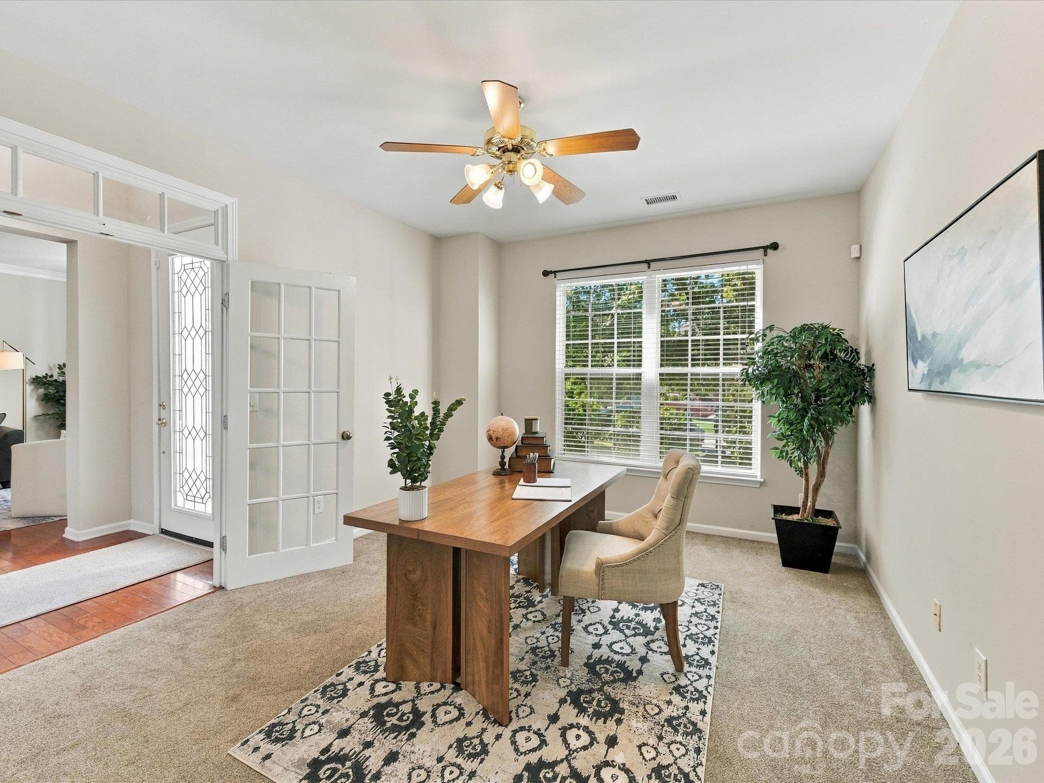 French doors open to a versatile flex space filled with natural light, offering the perfect setting for a home office, library, sitting room, or study. - 1788 Oakmont Drive, Denver